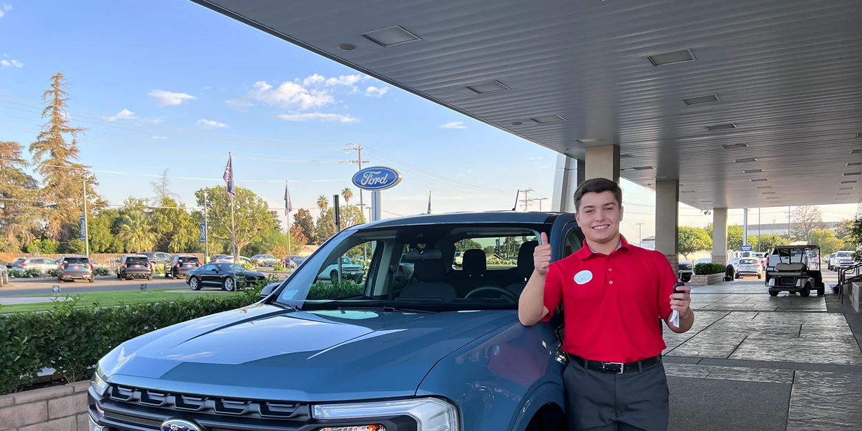 Noah standing in front of a truck.